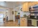 Kitchen with view into living room, wood cabinets, and tile floor at 2241 Heron Circle, Clearwater, FL 33762