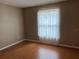 Bright bedroom with hardwood floors and a window with sheer curtains at 2251 Spruce Ln # A, Palm Harbor, FL 34684