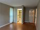 Bright bedroom with wood-look floors and access to bathroom at 2251 Spruce Ln # A, Palm Harbor, FL 34684