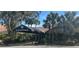 Community main entrance with covered walkway and landscaping at 2251 Spruce Ln # A, Palm Harbor, FL 34684