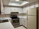 Clean kitchen featuring white cabinets and stainless steel appliances at 2251 Spruce Ln # A, Palm Harbor, FL 34684