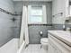 Updated bathroom with gray tile and white vanity at 229 Lime S Cir, Dunedin, FL 34698