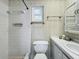 Small bathroom with shower, toilet and striped wallpaper at 229 Lime S Cir, Dunedin, FL 34698