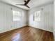 Simple bedroom with hardwood floors and two windows at 229 Lime S Cir, Dunedin, FL 34698