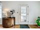 Bright entryway with wood half-moon table and a view to the front door at 229 Lime S Cir, Dunedin, FL 34698