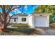 House exterior showcasing a white single-story home with attached garage at 229 Lime S Cir, Dunedin, FL 34698