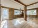 Living room with wood paneled walls and hardwood floors at 229 Lime S Cir, Dunedin, FL 34698