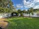 Landscaped backyard with lush green grass and mature trees at 25237 Seven Rivers Cir, Land O Lakes, FL 34639