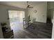 Modern dining room with glass table, white chairs, and gray flooring at 25237 Seven Rivers Cir, Land O Lakes, FL 34639