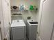 Laundry room with Samsung washer and dryer, and shelving at 25237 Seven Rivers Cir, Land O Lakes, FL 34639