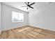 Bright bedroom with light wood floors, ceiling fan, and window blinds at 2608 W Columbus Dr # 5, Tampa, FL 33607