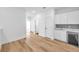 Bright hallway featuring wood floors and access to multiple rooms at 2608 W Columbus Dr # 5, Tampa, FL 33607