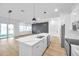 Modern kitchen with gray accent wall and white cabinets at 2608 W Columbus Dr # 5, Tampa, FL 33607