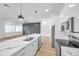 Modern kitchen with gray accent wall and white cabinets at 2608 W Columbus Dr # 5, Tampa, FL 33607