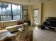 Bright living room with large windows and patio access at 2616 Cove Cay Dr # 102, Clearwater, FL 33760