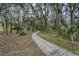 Peaceful walking path winds through lush trees and playground at 2815 Holly Bluff Ct, Plant City, FL 33566