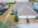 Aerial view of a home with a screened patio and two-car garage at 302 Latitude Pl, Apollo Beach, FL 33572