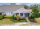 Aerial view of charming cottage with porch and landscaped yard at 302 Latitude Pl, Apollo Beach, FL 33572