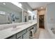 Elegant bathroom with double vanity and a walk-in shower at 302 Latitude Pl, Apollo Beach, FL 33572