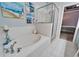 Bathroom featuring a garden tub, shower, and stylish decor at 302 Latitude Pl, Apollo Beach, FL 33572