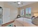 Bedroom with queen bed, wood floors and window shutters at 302 Latitude Pl, Apollo Beach, FL 33572