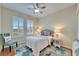 Bedroom with queen bed, ceiling fan, and window shutters at 302 Latitude Pl, Apollo Beach, FL 33572