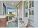 Inviting front porch with wicker chairs and screened enclosure at 302 Latitude Pl, Apollo Beach, FL 33572