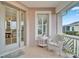 Relaxing front porch with white chair and side table at 302 Latitude Pl, Apollo Beach, FL 33572