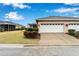 Attached two-car garage with white doors at 302 Latitude Pl, Apollo Beach, FL 33572