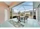 Relaxing screened porch with table and chairs, perfect for outdoor dining at 302 Latitude Pl, Apollo Beach, FL 33572