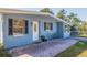 Front view of the light blue house with patio and seating at 3152 Karen Ave, Largo, FL 33774