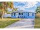 Front view of the light blue house with a driveway at 3152 Karen Ave, Largo, FL 33774