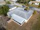 Aerial view showcasing the home's back and screened enclosure at 3220 Salisbury Dr, Holiday, FL 34691