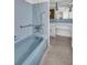 Retro bathroom with light blue tile, bathtub, and vanity at 3220 Salisbury Dr, Holiday, FL 34691