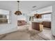 Kitchen with an island, wood cabinets and a view into the living room at 3220 Salisbury Dr, Holiday, FL 34691