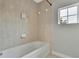 Clean bathroom with a bathtub and tiled walls at 4381 Caliquen Dr, Brooksville, FL 34604