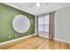 Bedroom with hardwood floors and a large circular accent wall at 4381 Caliquen Dr, Brooksville, FL 34604