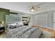 Main bedroom with hardwood floors and stylish bedding at 4381 Caliquen Dr, Brooksville, FL 34604