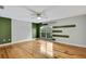 Bedroom with hardwood floors, ceiling fan, and green accents at 4381 Caliquen Dr, Brooksville, FL 34604