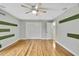 Bedroom with hardwood floors and an open door to another room at 4381 Caliquen Dr, Brooksville, FL 34604