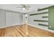 Bedroom with hardwood floors and green accent wall at 4381 Caliquen Dr, Brooksville, FL 34604