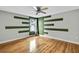 Bright bedroom featuring hardwood floors and unique wall design at 4381 Caliquen Dr, Brooksville, FL 34604