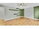 Bedroom with hardwood floors and green accent wall at 4381 Caliquen Dr, Brooksville, FL 34604