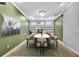 Elegant dining room features a modern oval table with chairs, built-in shelving, and an accent wall at 4381 Caliquen Dr, Brooksville, FL 34604