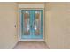 Double teal front doors with glass panes at 4381 Caliquen Dr, Brooksville, FL 34604