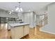 Kitchen island with granite countertop and hardwood floors at 4381 Caliquen Dr, Brooksville, FL 34604