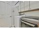 Bright laundry room with washer, dryer, and cabinets at 4381 Caliquen Dr, Brooksville, FL 34604