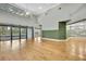 Living room with hardwood floors, green wall and pool view at 4381 Caliquen Dr, Brooksville, FL 34604