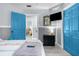 Bedroom with blue doors and a dresser, offering a calming atmosphere at 5421 Circle Dr, Weeki Wachee, FL 34607