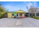 Quaint yellow cottage with gravel driveway and carport at 5421 Circle Dr, Weeki Wachee, FL 34607